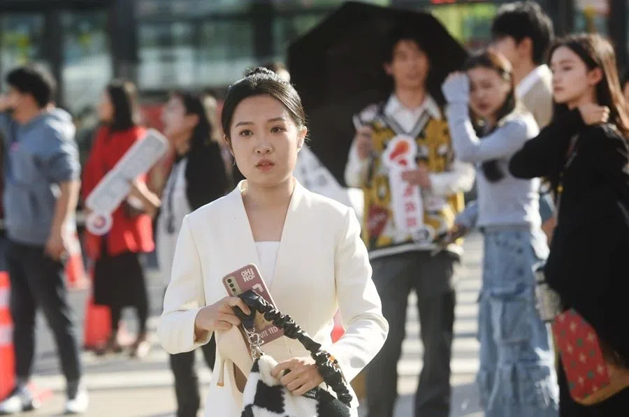 Students wait outside Zhejiang University of Media and Communications to take the 2024 Zhejiang Art Major National Examination in Hangzhou, Zhejiang province, China, on 10 December 2023.