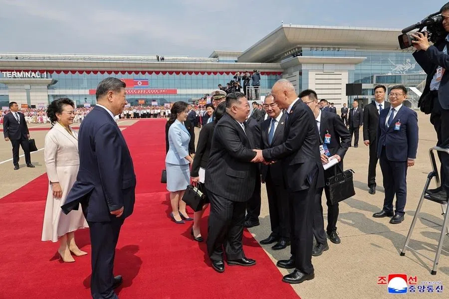 This picture taken on 9 June 2026 and released by North Korea's official Korean Central News Agency (KCNA) on 10 June 2026 shows North Korean leader Kim Jong Un (centre) exchanging farewell greetings with Cai Qi, member of the Standing Committee of the Communist Party of China's Political Bureau, Chinese Foreign Minister Wang Yi and other accompanying officials, who visited North Korea together with China's President Xi Jinping at Pyongyang International Airport.