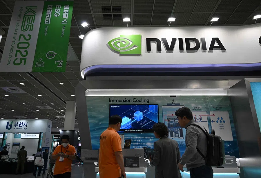 Visitors walk past the logo of Nvidia during the Korea Electronics Show 2025 at the COEX convention and exhibition centre in Seoul on 22 October 2025.