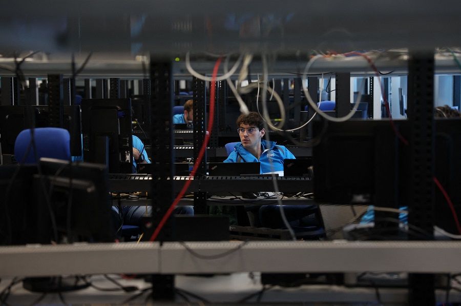 An employee of the European multinational information technology service and consulting company, Atos, is pictured at the company's cybersecurity centre in Madrid, in preparation for the 2024 Olympic Games in Paris, on 24 April 2023. (Pierre-Philippe Marcou/AFP)