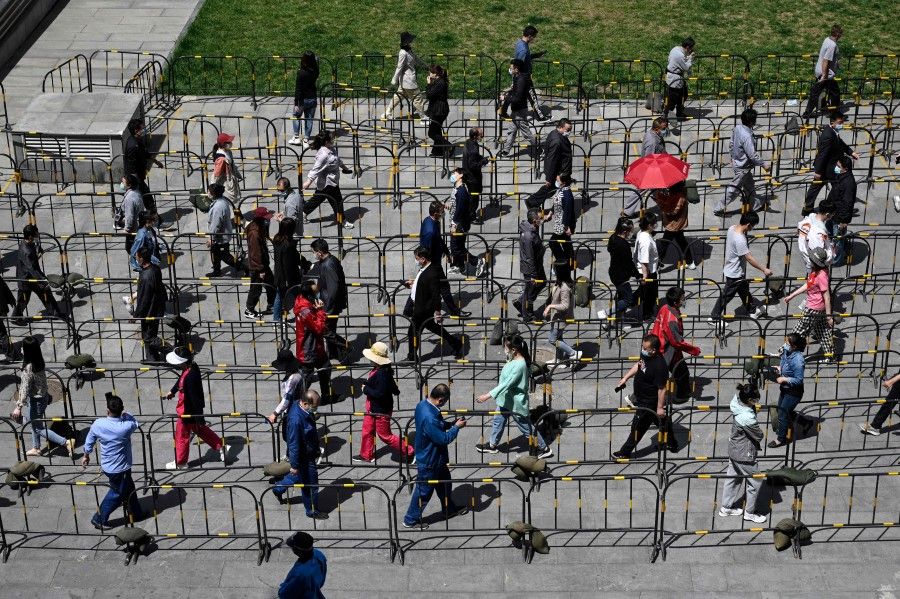 People line up to be tested for Covid-19 in Zhongguancun in Beijing on 26 April 2022. Beijing has launched mass coronavirus testing for nearly all of its 21 million residents, as fears grew that the Chinese capital may be placed under a strict lockdown like Shanghai. (Jade Gao/AFP)