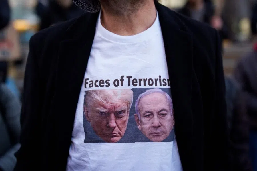 A person wears a T-shirt with images of US President Donald Trump and Israeli Prime Minister Benjamin Netanyahu during a protest against the war in Iran on 2 March 2026 in New York, New York. (Adam Gray/AFP)