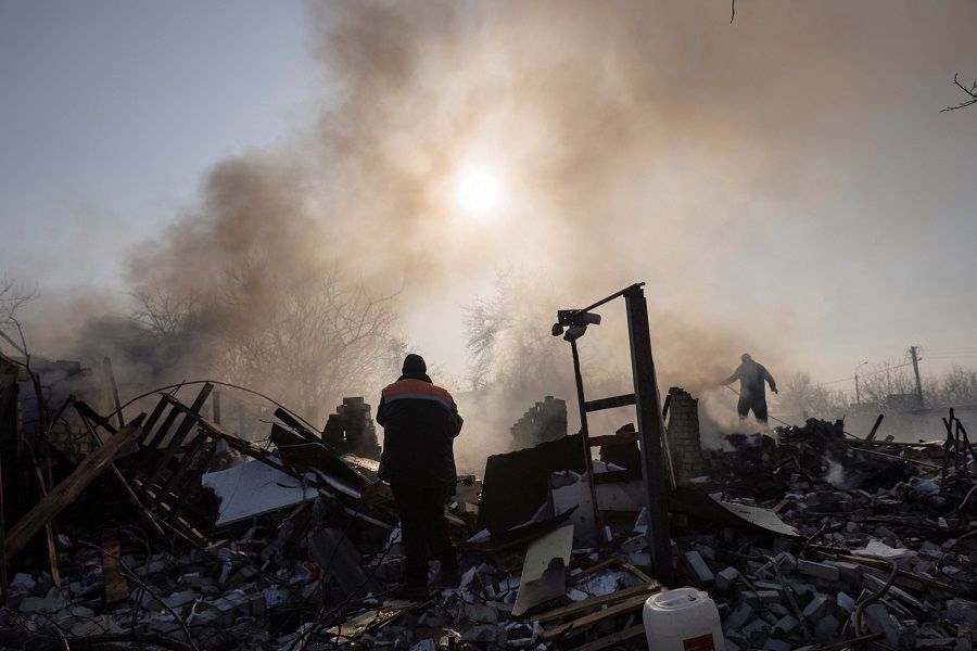 Residents extinguish a fire after a bombing destroyed a family home in a northern district of Kharkiv as Russia's attack on Ukraine continues, in Ukraine, 24 March 2022. (Thomas Peter/Reuters)