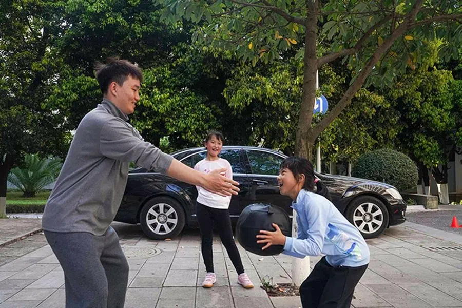 Trainer Hu Yutao demonstrates an exercise to his students.