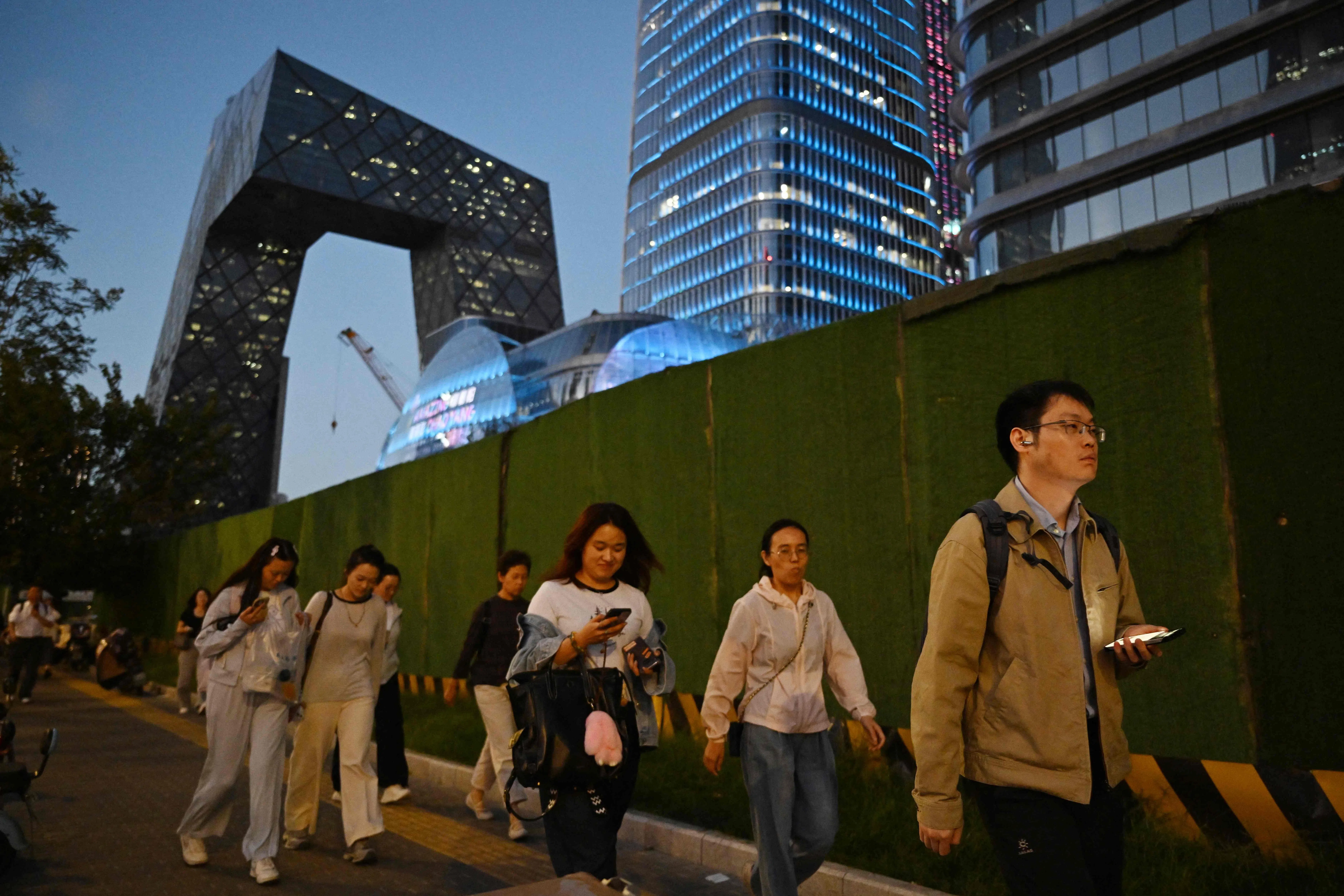 People walk in the central business district in Beijing on 11 September 2026.