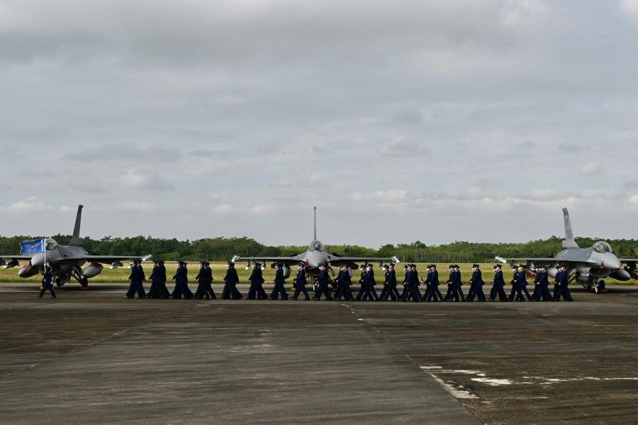 Taiwan Air Force staffers walk past the upgraded US-made F-16 V fighters during a ceremony at the Chiayi Air Force in southern Taiwan on 18 November 2021. (Sam Yeh/AFP)