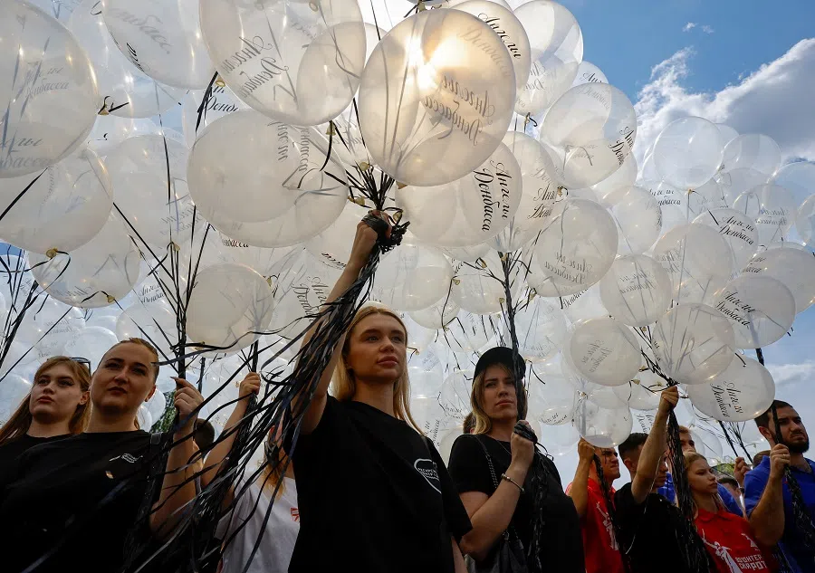 Activists get ready to release balloons in memory of children killed in the course of Russia-Ukraine conflict on Donbas, in Donetsk, Russian-controlled Ukraine, 27 July 2024. (Alexander Ermochenko/Reuters)