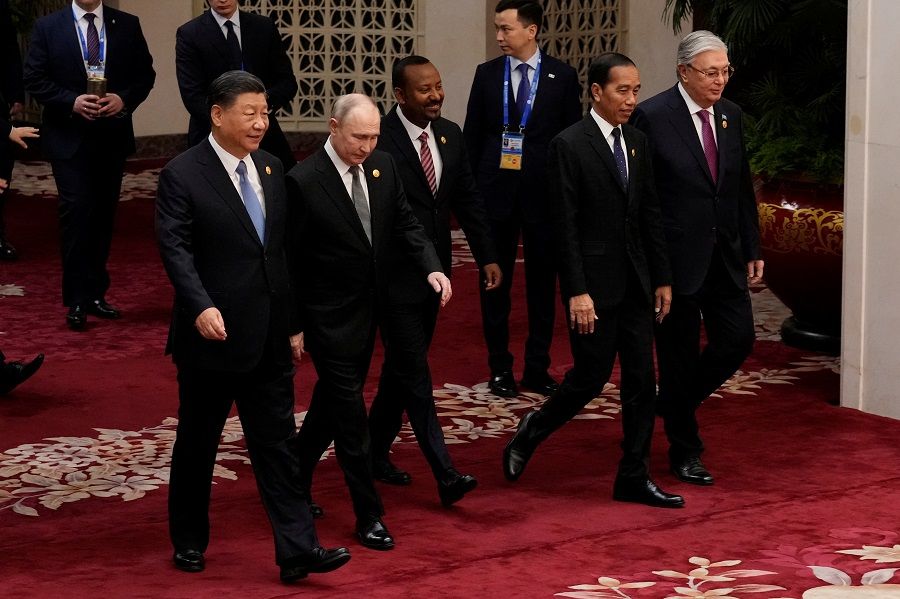 (left to right) Chinese President Xi Jinping, Russian President Vladimir Putin, Ethiopian Prime Minister Abiy Ahmed, Indonesian President Joko Widodo and Kazakhstan President Kassym-Jomart Tokayev head to a group photo session at the third Belt and Road Forum in Beijing, China, on 18 October 2023. (Suo Takekuma/Pool via Reuters)