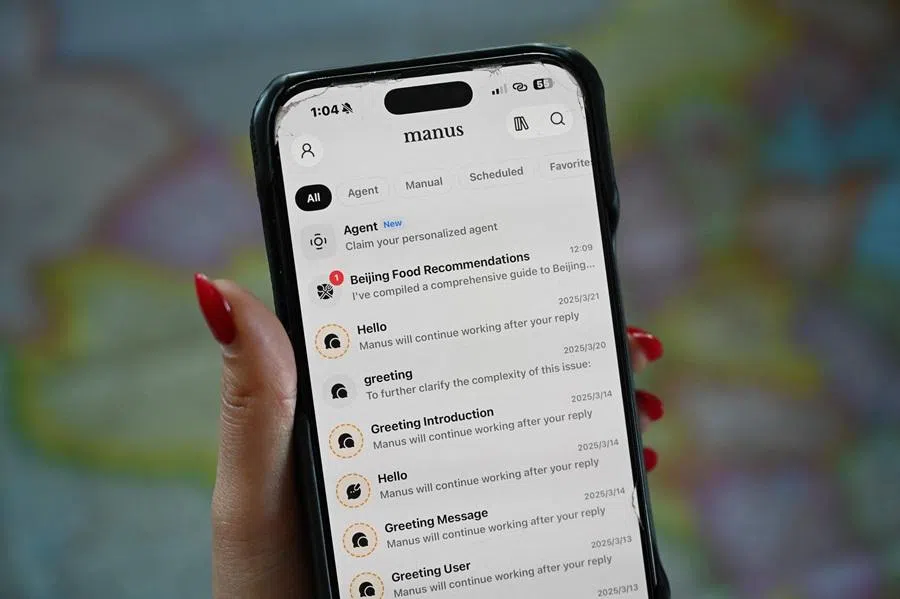 This photo illustration shows the Manus app on a mobile phone in Beijing on 28 April 2026. (Greg Baker/AFP)