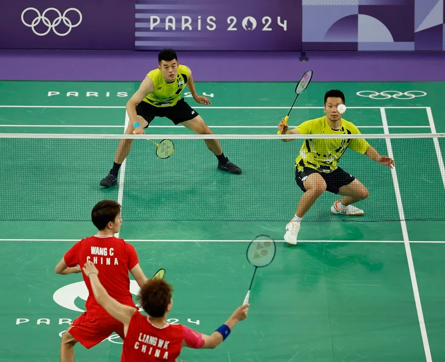 Wang Chi-lin and Lee Yang of Chinese Taipei in action against Liang Weikeng and Wang Chang of the People’s Republic of China in the badminton men’s doubles gold medal match at the Paris 2024 Olympics, on 4 August 2024. (Hamad Mohammed/Reuters)