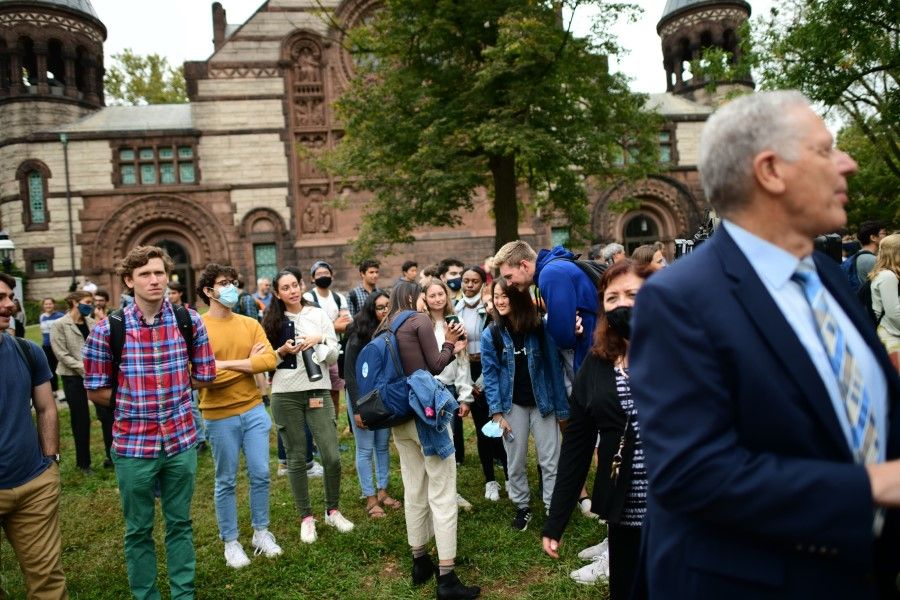 Princeton University students react while watching video of senior meteorologist Syukuro Suki Manabe at a press conference after he was awarded a share of the 2021 Nobel Prize in physics at Princeton University on 5 October 2021 in Princeton, New Jersey. (Mark Makela/Getty Images/AFP)