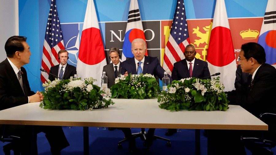 Japanese Prime Minister Fumio Kishida (right) at a trilateral session with the US and South Korea during a NATO summit in Madrid, Spain, 29 June 2022. (Jonathan Ernst/Reuters)