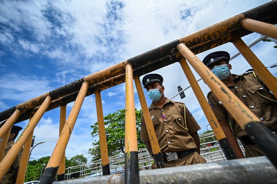 Police stand guard near the parliament building in Colombo, Sri Lanka, on 17 May 2022. (Ishara S. Kodikara/AFP)