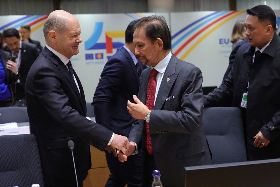 Germany's Chancellor Olaf Scholz (left) shakes hands with Sultan of Brunei Darussalam Haji Hassanal Bolkiah at the start of the EU-ASEAN summit at the European Council headquarters in Brussels on 14 December 2022. (Olivier Matthys/AFP)