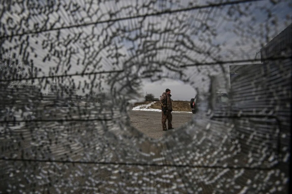 A Ukrainian serviceman stands at a check point in the vilage of Velyka Dymerka east of Kyiv, on 9 March 2022. (Aris Messinis/AFP)