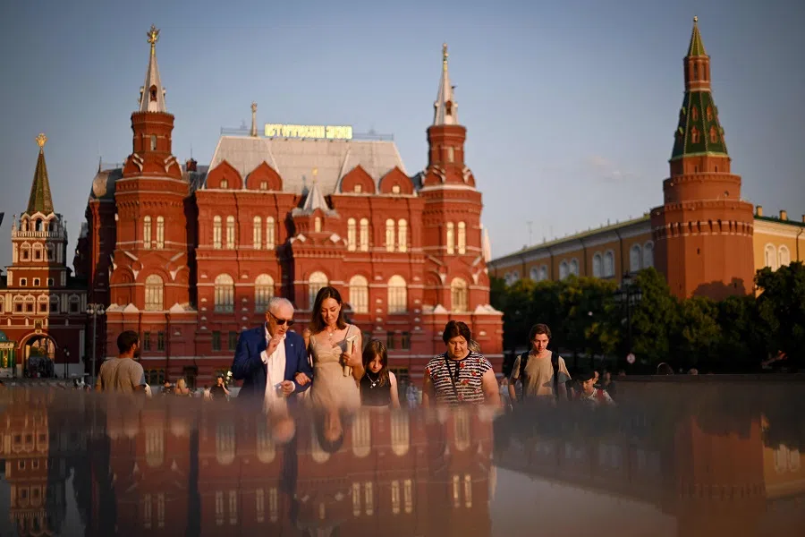 People walk along a street in central Moscow, Russia, on 16 June 2023. (Natalia Kolesnikova/AFP)