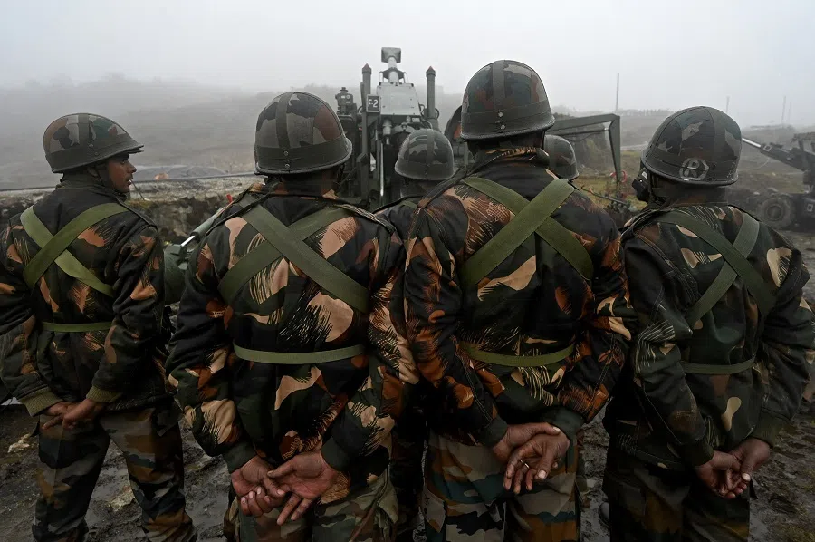 Indian Army soldiers stand next to a Bofors gun positioned at Penga Teng Tso ahead of Tawang, near the Line of Actual Control (LAC), neighbouring China, in India's Arunachal Pradesh state on 20 October 2021. (Money Sharma/AFP)