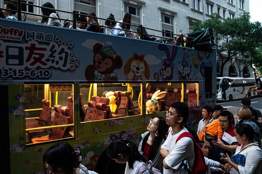 Tourists queue for a bus at the Tsim Sha Tsui district during Labor Day holiday in Hong Kong, China, 1 May 2024. (Lam Yik/Bloomberg)