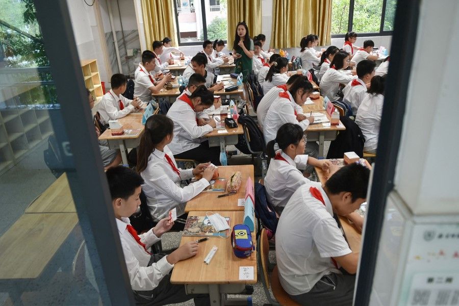 Students return to school for the new semester as schools reopen after a Covid-19 coronavirus outbreak in the city of Nanjing, in China's eastern Jiangsu province on 9 September 2021. (STR/AFP)