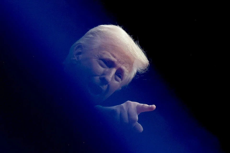 US President Donald Trump gestures at the inaugural parade inside Capital One Arena on the inauguration day of his second presidential term, in Washington, US, on 20 January 2025. (Carlos Barria/Reuters)