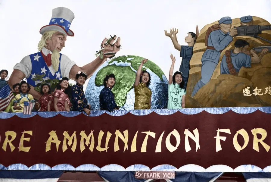 The Chinese in San Francisco arranged a float parade to welcome Madame Chiang, April 1943. Uncle Sam holds planes, tanks, and ships, reaching across the globe to give them to China, as represented by a Chinese figure, backed by valiant Chinese soldiers. Madame Chiang stayed in San Francisco for five days.