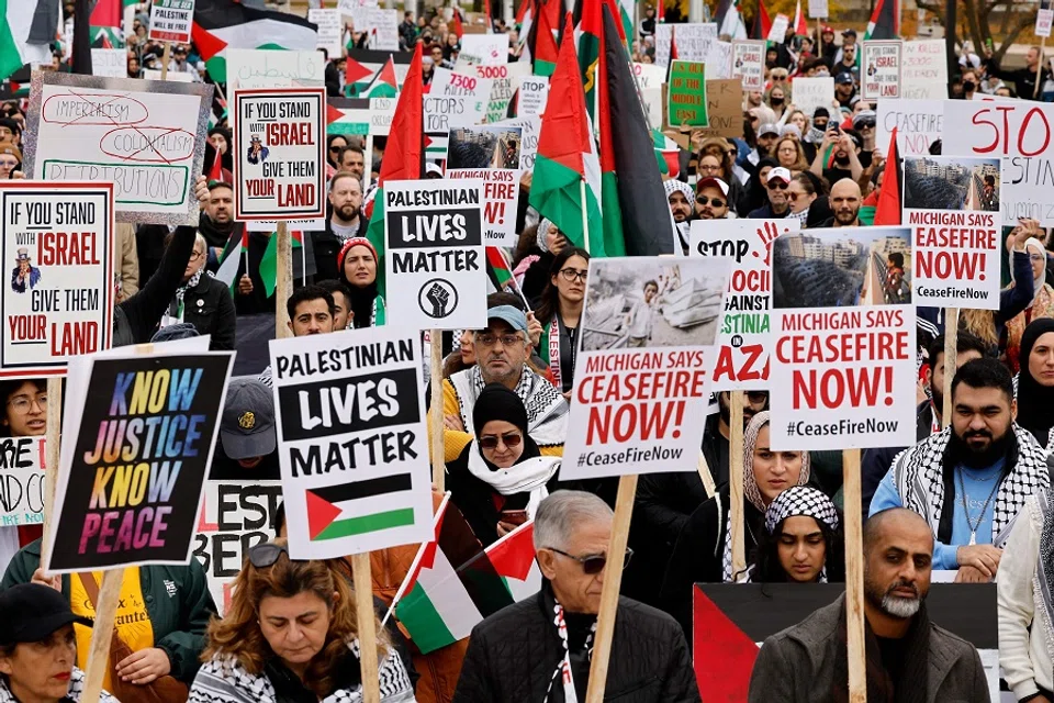 People hold signs as they gather in Hart Plaza in downtown Detroit, Michigan, US, to call for a ceasefire and voice their support for the Palestinian cause on 28 October 2023. (Jeff Kowalsky/AFP)