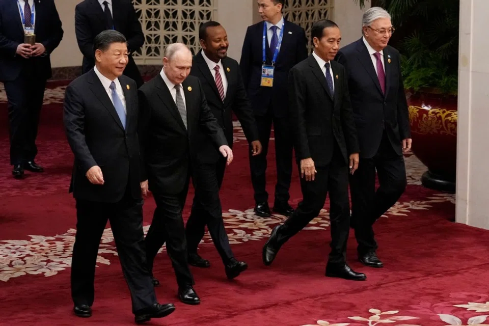 (Left to right) China's President Xi Jinping, Russia's President Vladimir Putin, Ethiopia's Prime Minister Abiy Ahmed, Indonesia's President Joko Widodo and Kazakhstan's President Kassym-Jomart Tokayev head to a group photo session at the third Belt and Road Forum for International Cooperation at the Great Hall of the People in Beijing on 18 October 2023. (Suo Takekuma/AFP)