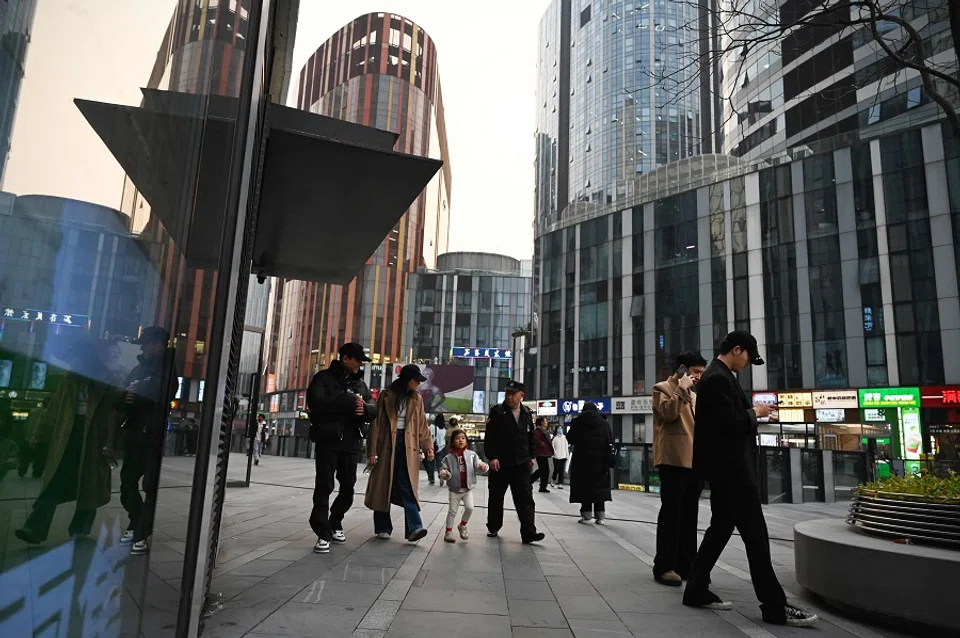People walk in a shopping mall in Beijing, China, on 8 November 2024. (Greg Baker/AFP)
