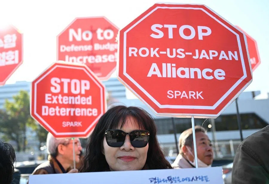 Anti-war activists hold placards during a protest against visiting US Defense Secretary Pete Hegseth outside the Defence Ministry in Seoul on 4 November 2025.