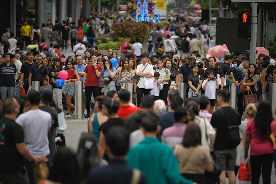 People wait to cross Orchard Road in Singapore. (SPH Media)