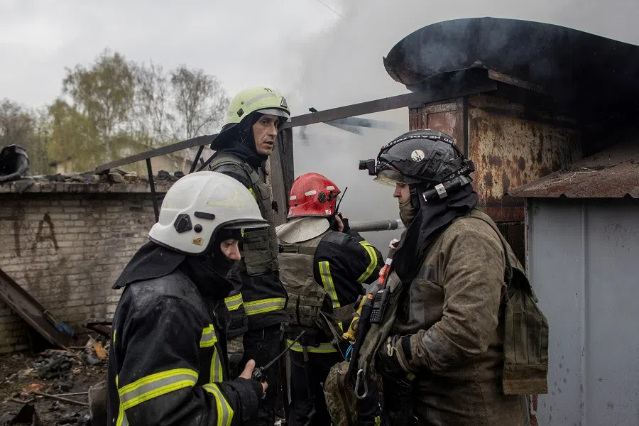 Firefighters try to extinguish a fire burning at a garage, following Russian shelling, amid Russia's attack on Ukraine, in Kharkiv, Ukraine, 18 April 2022. (Alkis Konstantinidis/Reuters)