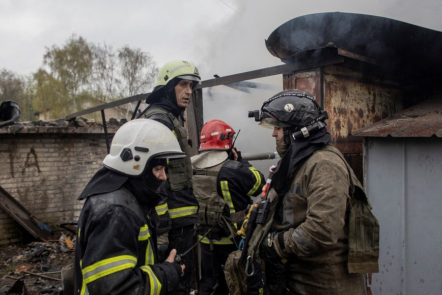 Firefighters try to extinguish a fire burning at a garage, following Russian shelling, amid Russia's attack on Ukraine, in Kharkiv, Ukraine, 18 April 2022. (Alkis Konstantinidis/Reuters)