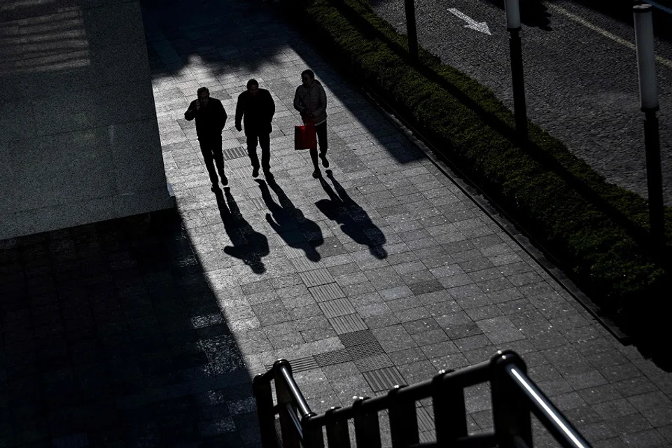 People walk along a street in the Jing’an district in Shanghai, on 18 March 2025. (Hector Retamal/AFP)