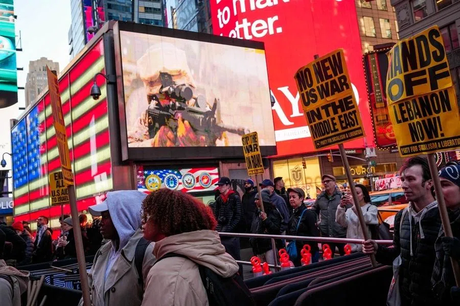 People take part in a protest in Times Square against the US-Israeli conflict with Iran, and against conflict in Lebanon and Gaza, in New York City, US, on 8 April 2026.