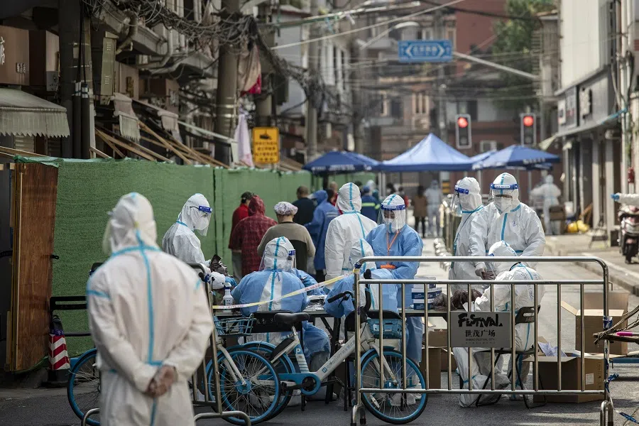 Workers in PPE prepare test kits for a neighborhood during a lockdown due to Covid-19 in Shanghai, China, on 3 May 2022. (Bloomberg)