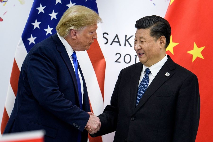 Presidents Donald Trump and Xi Jinping shake hands in a file photo from the G20 Summit in Osaka in June 2019. (Brendan Smialowski/AFP)