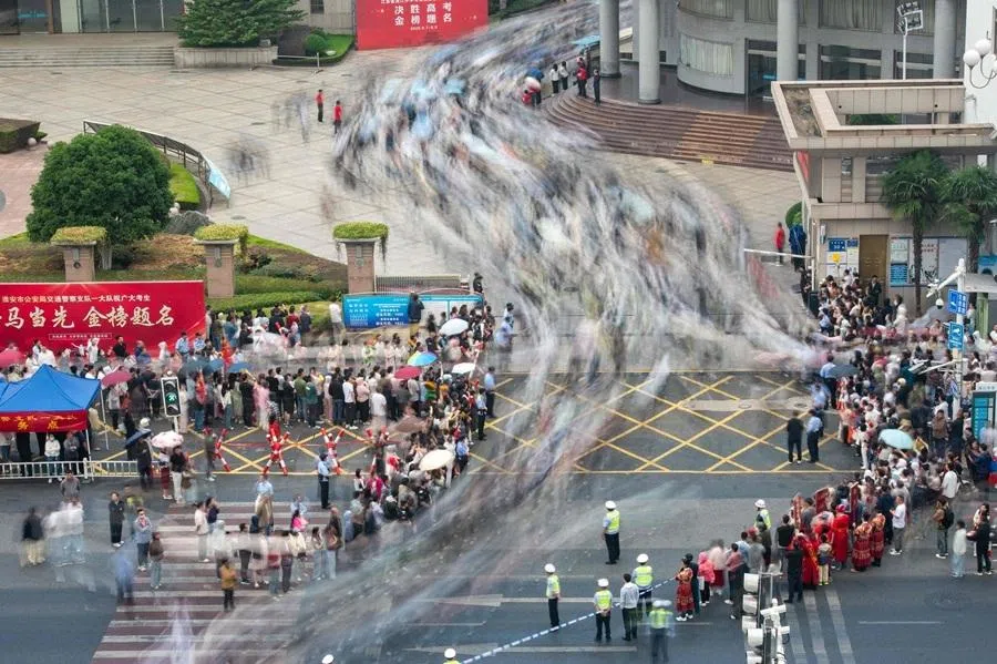 In this long exposure photo, students arrive at a school to sit for their gaokao, in Huai’an, Jiangsu province, China on 7 June 2026.