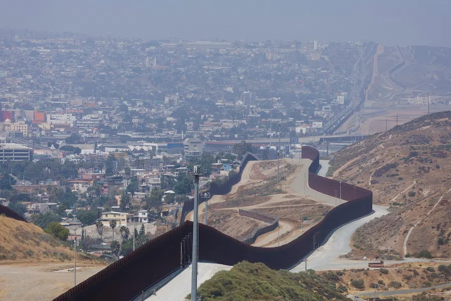 The primary and secondary border walls between the United States and Mexico are shown along the San Diego sector with Tijuana, Mexico in the background looking southwest from San Diego, Californian, US, 9 June 2022. (Mike Blake/Reuters)