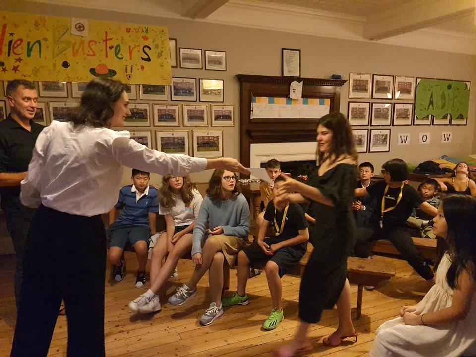 A teacher hands a graduation certificate to a student at the end of a study tour in the UK last summer. (Photo provided by interviewee)