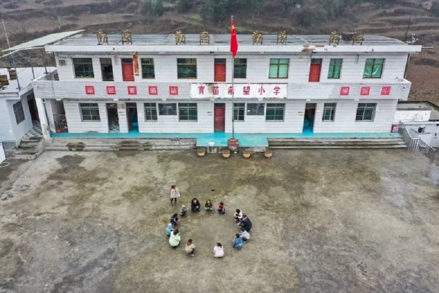 Students are playing games during recess at Fengping Primary School in Qianxi, Guizhou province, on 15 February 2023. The school has only 30 students. (Photo: Caixin)