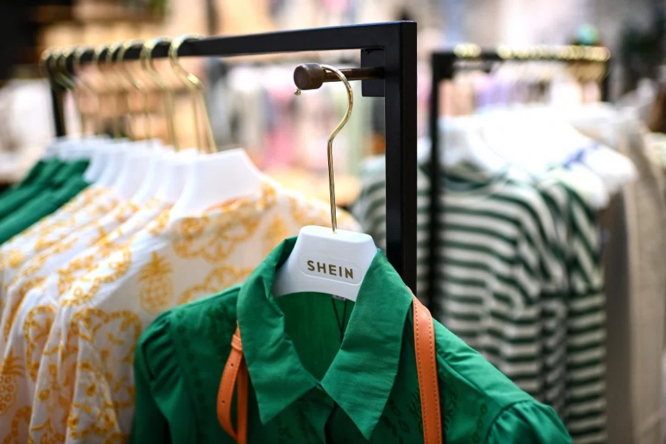 Clothes are displayed on hangers at a Chinese fashion brand Shein pop-up store in Paris, France, on 4 May 2023. (Christophe Archambault/AFP)