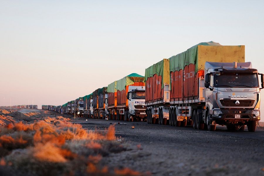 This picture taken on 16 October 2021 shows trucks loaded with coal waiting near Gants Mod port at the Chinese border with Gashuun Sukhait, in Ömnögovi province, in Mongolia. (Uugansukh Byamba/AFP)