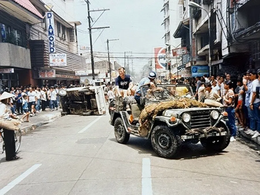 A Hong Kong film crew shooting A Better Tomorrow III on the streets of the Philippines, with Manila standing in for Saigon during its fall.