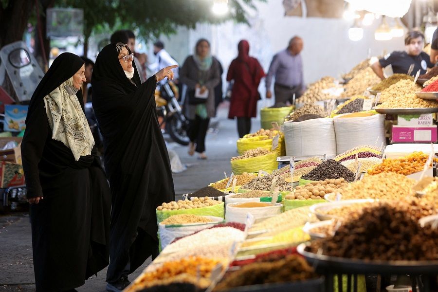 People shop in a market as the prices of some goods increased, in Tehran, Iran, 16 May 2022. (Majid Asgaripour/WANA (West Asia News Agency) via Reuters)