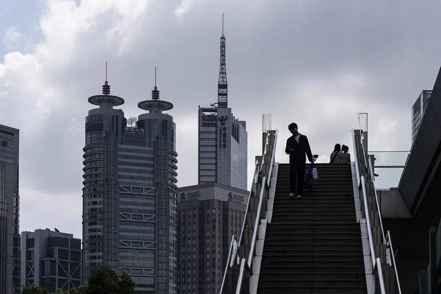 Pedestrians in Pudong’s Lujiazui Financial District in Shanghai, China, on 14 August 2024. (Qilai Shen/Bloomberg)