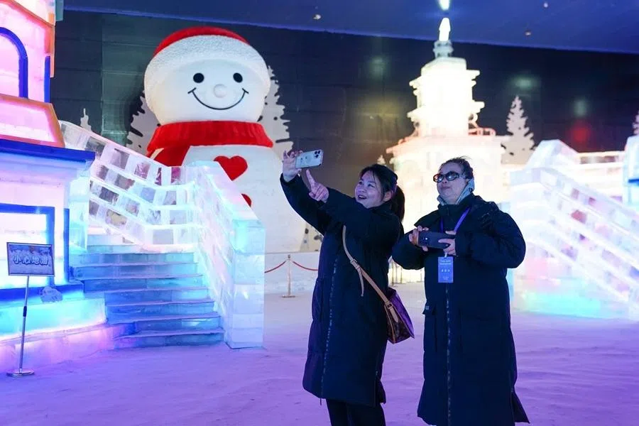Tourists take pictures at the Dream Ice and Snow Pavilion in Harbin, Heilongjiang, on 9 June 2026.