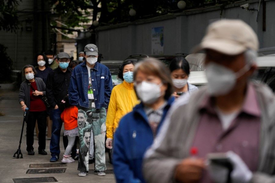 Residents line up for nucleic acid tests during lockdown, amid the Covid-19 pandemic, in Shanghai, China, 9 May 2022. (Aly Song/Reuters)