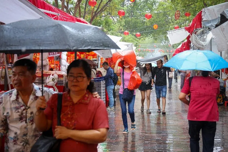 Shoppers braving the rain at Albert Street, Singapore, on 16 February 2026. (SPH Media)