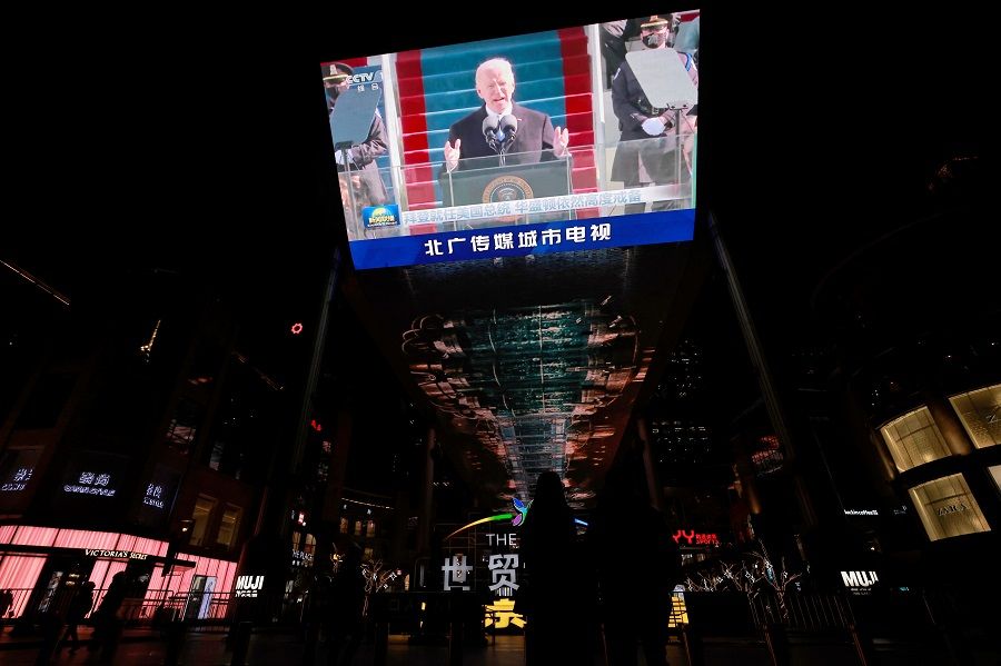 A screen shows a CCTV state media news cast of the inauguration of US President Joe Biden, at a shopping centre Beijing, China, 21 January 2021. (Thomas Peters/Reuters)