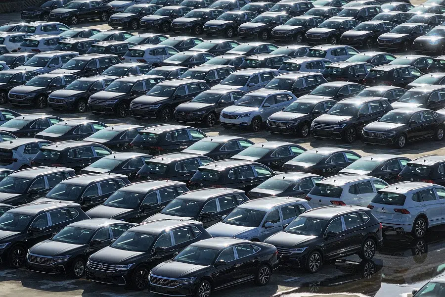 This photo taken on 23 June 2024 shows and aerial view of Volkswagen cars to be loaded onto a ship at a port in Nanjing, in eastern China’s Jiangsu province. (AFP)